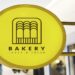 Bakery store's yellow shop sign mockup