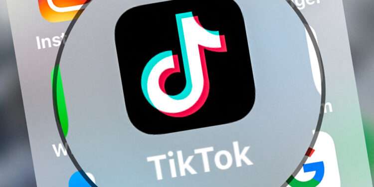 This photograph taken on March 23, 2022, shows logo of the networking application TikToK displayed on a tablet in Lille, northern France. (Photo by DENIS CHARLET / AFP)