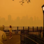 Traveling smoke from Canada's wildfires created an orange-tinged smog that shrouded New York City on Wednesday, obscuring its famous skyscrapers and causing residents to don face masks, as cities along the US East Coast issued air quality alerts.