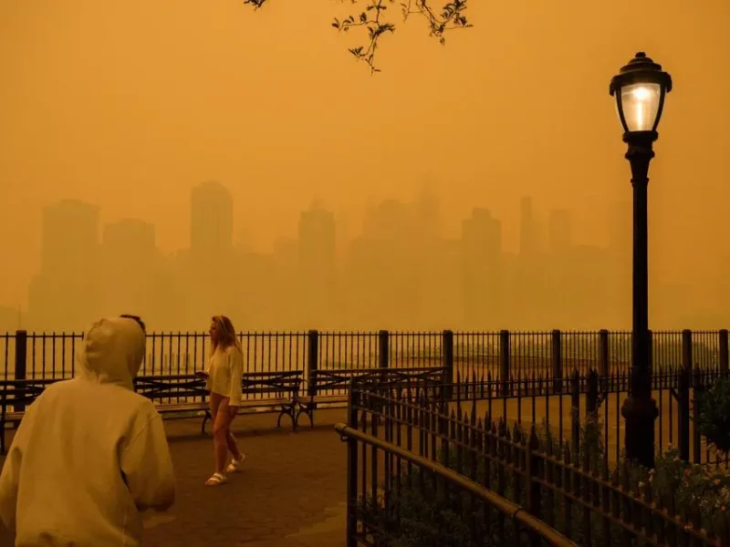 Traveling smoke from Canada's wildfires created an orange-tinged smog that shrouded New York City on Wednesday, obscuring its famous skyscrapers and causing residents to don face masks, as cities along the US East Coast issued air quality alerts.