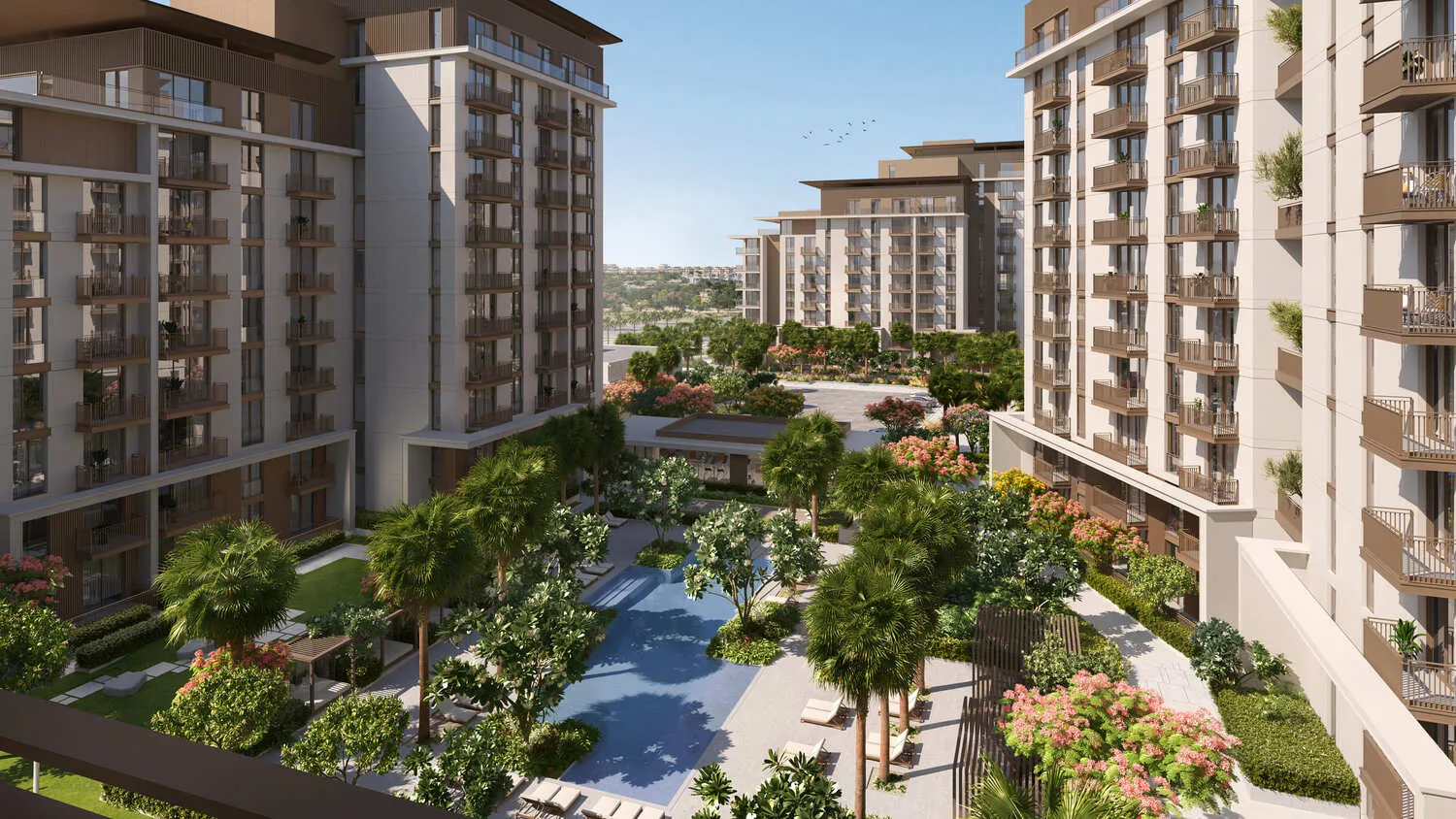 Aerial view of a luxurious residential complex with modern apartment buildings, a swimming pool, palm trees, and lush greenery in Madinat Jumeirah Living, Dubai.